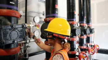HMT female-worker-on-valves-1024x683-1-650x360